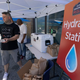 A man handing out water during a heat wave.